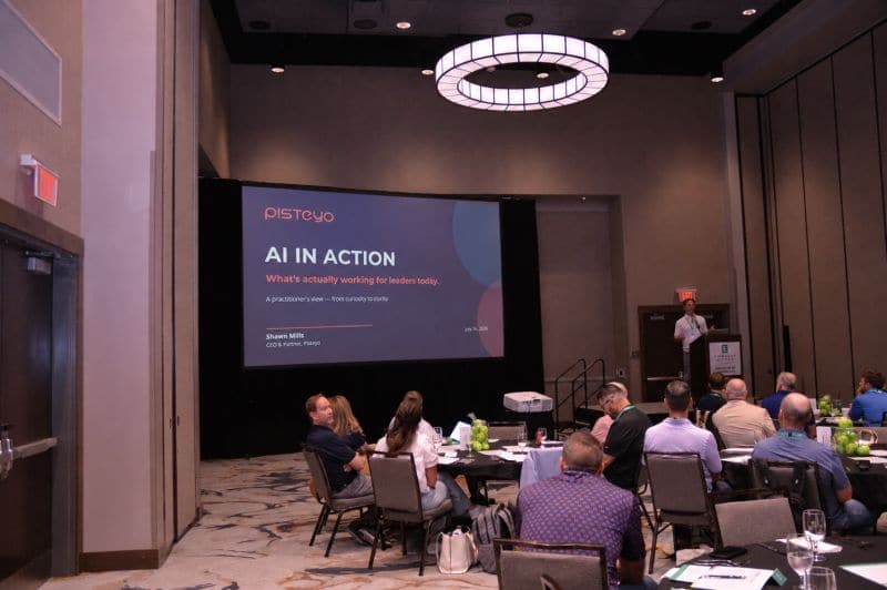 Shawn Mills presenting an AI in Action briefing to a seated room of executives